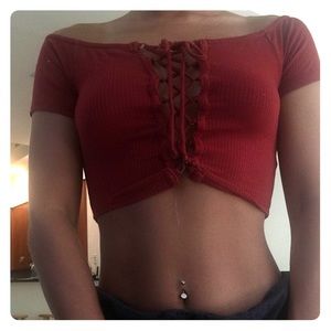 A croptop maroon tie front shirt off the shoulder